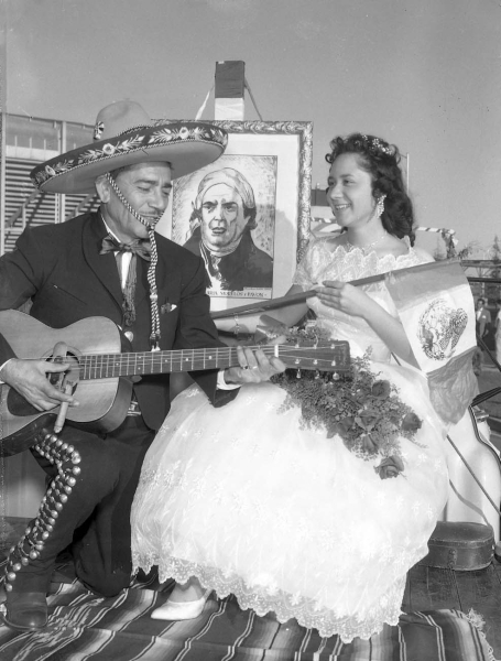 Tony Espinoza serenades beauty queen Hortensia Blanco in the Mexican Independence Day Parade, 1959.